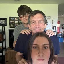 What is the name of the priest in the family photo from 1970 at St.  Joseph's Catholic church?