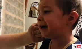 Young boy freaks out when dad 'takes' his nose and ear