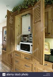oak kitchen cupboard with doors open to