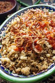 Kushari Egyptian Rice Lentils And Pasta With Spicy Tomato Sauce Foodtasia Recipe Food Egyptian Food Spicy Tomato Sauce