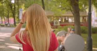 There quite literally is no hair look that highlights can't achieve. Closeup Back View Portrait Of Young Blonde Long Haired Cute Female Walking In Park Turning And Looking At Camera With Her Hair Flattering Outdoors Stock Video C Footage Ua 301253060