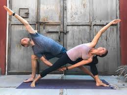 Releasing the tensions around the shoulders, arms and neck, with a simple twist of the upper body in this pose. Couple S Yoga Poses 23 Easy Medium And Hard Duo Yoga Poses Yoga Poses For Two Couples Yoga Poses Partner Yoga Poses