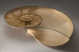 This coffee table combines metal and glass. 25 Awesome Unusual Coffee Tables