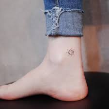Minimalist Sun And Moon Tattoo On The Ankle Ankle Tattoo Designs Moon Tattoo Ankle Tattoos For Women