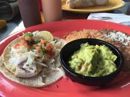 Brush fish with oil, season with 1/4 tsp each salt and pepper, and grill until lightly charred and opaque throughout, 2 to 5 minutes per side (depending on the fish). Fish Taco Grilled Fish With Side Of Guacamole And Beans Picture Of Paco S Tacos Cantina Kauai Tripadvisor