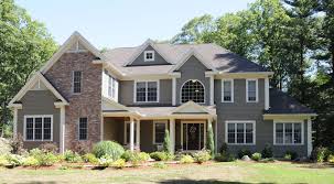 In this brick house example, the dark sandy grout color was used as a siding color, and it coordinates beautifully with the earthy shades in the brick. Peaks Gray Siding With Brick Classic House Red Brick House Grey Siding