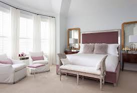 In this interior, dark wood floors and furniture make dusky blush and salmon pink look especially vivid. Mauve Bedroom With Gray Cane Bench Transitional Bedroom