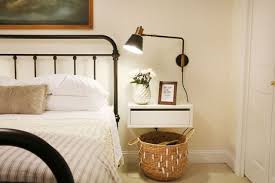 Wicker Basket Striped Blanket White Bedding Metal Black Finished Bed White Vase Flowers Wall Sconce White Floating Nightstand With Drawer Wooden Framed Art Pieces Cool Ideas Of Floating Bedside Tables And Nightstands