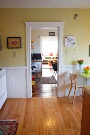 The original purpose of chair rail molding, specifically dining room chair rail, was to protect walls from being damaged by chair backs. Boston Emily And Nate House Tour Apartment Therapy Yellow Kitchen Walls White Chair Rail Yellow Kitchen