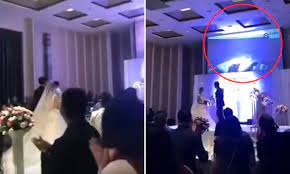 Groom plays a video of his bride in bed with her brother