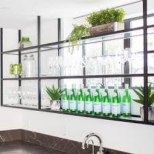 Diy glass shelves in front of kitchen window treatments. Glass And Iron Bar Shelf In Front Of Windows Glass Bar Shelves Glass Shelves Kitchen Glass Shelves