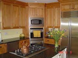 Custom Light Stained Kitchen Cabinetry With Black Countertops Stained Kitchen Cabinets Custom Cabinetry Cabinetry