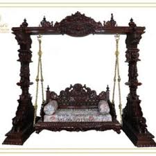 Wooden swings both side two pillar stand and supporting for the central swing.wooden jhoola shows the artistic arched design on the below portion carved intricately. Amazing Antique Wooden Swing Jhula For Living Room