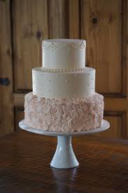 Ivory And Pale Pink Buttercream Wedding Cake Random Rosettes On The Bottom Simple Wedding Cake Pink Wedding Cake Rosette Cake Wedding