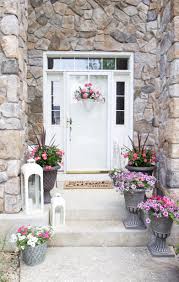 Use a pretty area rug to anchor the space. Decorating With Potted Flowers On The Front Porch A Gardening And Outdoor Entertaining Blog Hop Styled With Lace