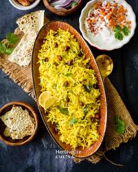 Tangy lemon rice tempered with curry leaves, mustard seeds, and lemon juice served with pickle