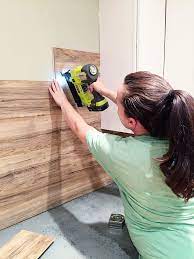 Using laminatewood flooringgives a modern and homey look that's less expensive than tile or real wood, and way easier to install. Laminate Flooring Backsplash It Looks Like Wood Bower Power Flooring On Walls Pallet Walls Home Remodeling