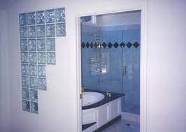 The designs scatter light as it penetrates the glass to provide varying degrees of transparency. Jacuzzi And Glass Block Bathroom Remodel