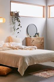 But when it comes to styling the surface, limit yourself to just a few bedroom essentials to keep it from getting cluttered—like an alarm clock, a lamp, and maybe a framed photo and a plant for a personal touch! Kari Channeled Quilt Simple Bedroom Decor Essentials Bedroom Design