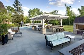 With flags, you can create campfire vibes, simple and elegant looks that are more in line with conventional designs. Blue Stone Patio With Pergola Fire Pit Northbrook Decks Pergolas Stone Paver Patios
