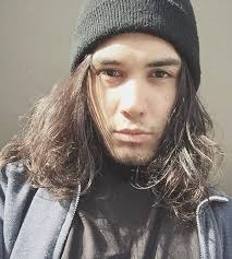 Many celebrities are examples of how women can wear their hair in any style. A Photograph Of A Native American Guy With Very Long Wavy Hair Posing For The Camera As He Wears A Beanie During A Photoshoot At Our Barbershop Long Hair Guys