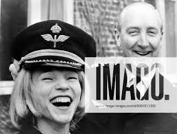 COLONEL IAN IACOBI WITH EVA NELSON TRIES ON CAP IN SWEDEN ; 20 APRIL