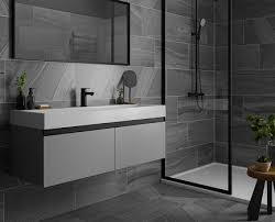 The floating vanity with a large white bathtub adds to the look of this décor, giving it a modern look. Bathroom Tiles Bathroom Wall Tiles Tile Giant