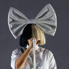 Why Does Sia Cover Her Face With A Wig Here S The Answer Allure Most often, sia steps out wearing a cropped wig that covers the majority of her face — leaving her mouth free to speak and sing — occasionally with an accessory perched on top, like a hat or whopping white bow. why does sia cover her face with a wig