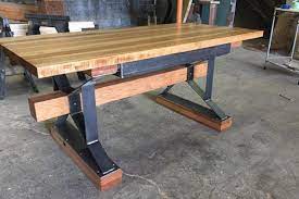 Made from concrete this table has a square pedestal base and a large square tabletop that'll be able to hold all your cool books, some succulents, and keep a beverage close by. Modern Industrial Hickory Desk The Industrial Farmhouse