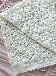 Newborn baby laying with teddy bear on blanket. Free Knitting Pattern For Thine Receiving Blanket Beautiful Baby Blan Knit Baby Blanket Pattern Free Knitting Patterns Free Blanket Blanket Knitting Patterns