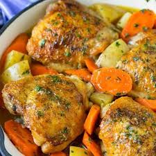 Braised Chicken Thighs With Carrots And Potatoes In A Skillet Braised Chicken Recipes Braised Chicken Thighs Braised Chicken