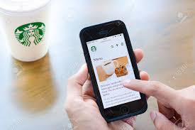 A cup of coffee is 98 percent water. Hand Holding Smart Phone Opening Online Menu Web Page Of Starbucks Stock Photo Picture And Royalty Free Image Image 53810512
