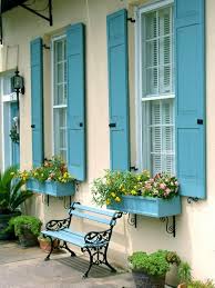 A shiny window with blinds and shutters is beside the door. Bright And Colorful Shutters That Add Instant Curb Appeal Southern Living