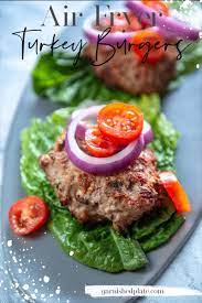 Flip halfway through the cooking process, so both sides cook up perfectly. Air Fryer Turkey Burgers Garnished Plate