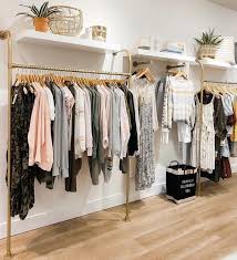 Store clothing racks for sale. Gold Wall Mounted Curved Clothing Rack Clothing Store Design Clothing Store Interior Boutique Clothing Rack