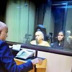 Glass barrier between Jadhav, family;