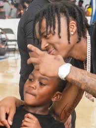 Nah'Shon Hyland, NBA player from Wilmington, holds basketball showcase