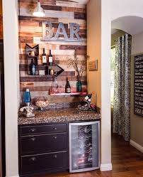 Cabinets lined along one wall boasting a sink, open shelving, and a refrigerator. 59 Cool Basement Bar Design Ideas 2021 Guide