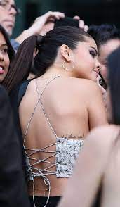 Its the number 76 in roman numerals, its 'dedicated to a close family member'. Beautiful Back Detail B Amp W Fashion Selena Gomez Tattoo Hidden Tattoos Celebrity Tattoos