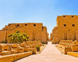 Image of archaeologists studying and documenting the inscriptions and reliefs at Karnak, highlighting the ongoing efforts to decipher and interpret the temple's historical record.