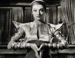 retrofuturistic clothing is a particular imagined vision of the clothing that might be worn in the distant future, typically found in science fiction and science fiction films of the 1940s onwards, but also in journalism and other popular culture. Myrna Loy Retro Futuristic Futuristic Clothing Sci Fi Movie Fu Manchu Retro Futuristic Retro Futurism