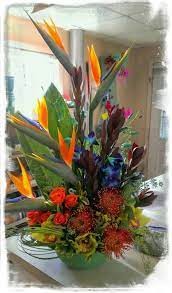 Tropical Arrangement Of Blue Dendrobium Orchids Birds Of Paradise Protea Green Cymbi Tropical Floral Arrangements Blue Dendrobium Orchids Dendrobium Orchids