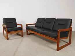 This lot is offered without reserve. Black Leather Teak Danish Sofa Chair By Holstebro Mobelfabrik 96154