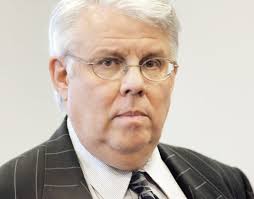 Oklahoma man convicted of swindling coach gets less prison time