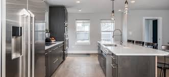 Black transitional kitchen design with contemporary black cabinets with stainless steel hardware along with stainless steel appliances and dark wood floor. Black Stainless In Herndon Va With Ge And Kitchenaid Appliances And Shrock Cabinetry Bray Scarff Appliance Kitchen Specialists Bray Scarff Appliance Kitchen Specialists