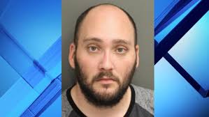 Man accused of posing as cop arrested