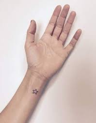 This graceful wrist tattoo features yet another moon design, but this time there is also a small stalk of flowers accompanying this moon tattoo. Tattoo Wrist Star Simple 44 Super Ideas Simple Wrist Tattoos Star Tattoo On Wrist Small Star Tattoos