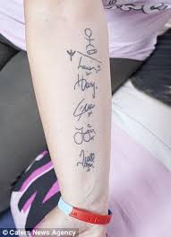 The tattoo looks like a small x, and each of the members of one direction has one. One Direction S Oldest Superfan 47 Has 20 Tattoos Dedicated To The Band S Teenage Heart Throbs Daily Mail Online