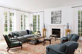 Take a wreath and cover it with simple white ribbon, to enhance the beauty of your christmas fireplace décor, place this wreath near fire place while adding some colorful lights to it. White Fireplace Inspiration Architectural Digest
