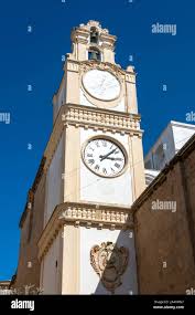 Gallipoli, Italy. The bell tower of the Cathedral Basilica of St. Agatha,  built in the early 1700, also with a clock and a sundial Stock Photo